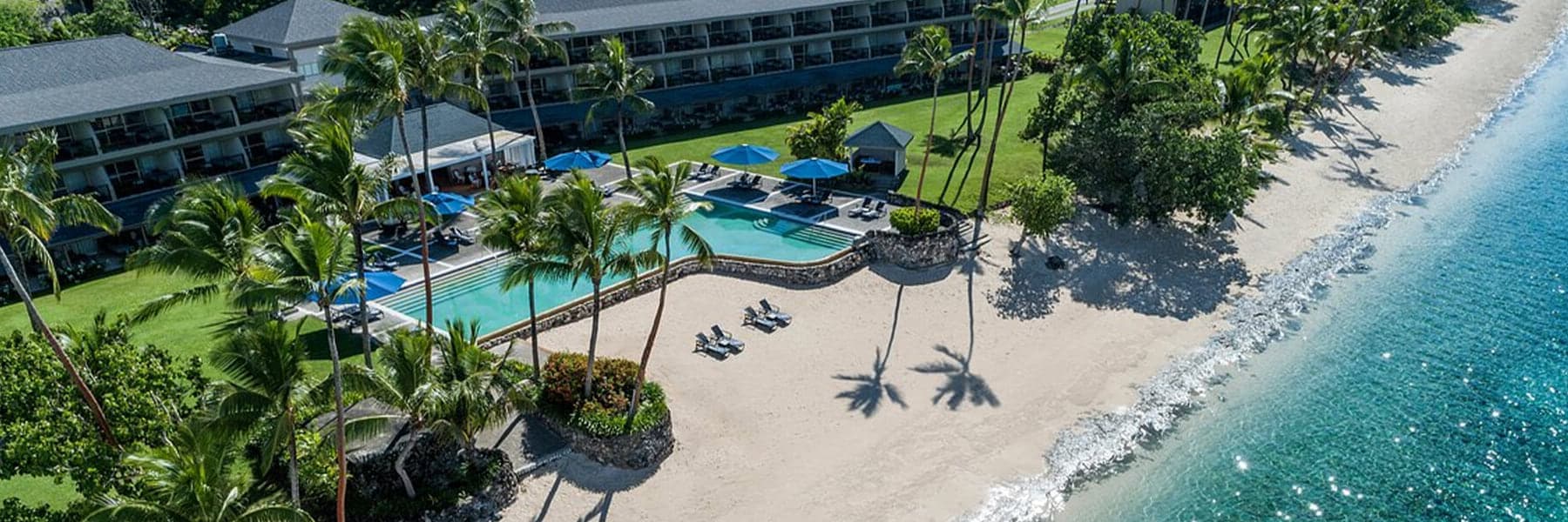 Aerial view of the Shangri-La Yanuca Island resort in Fiji with pool, beach and palm groves